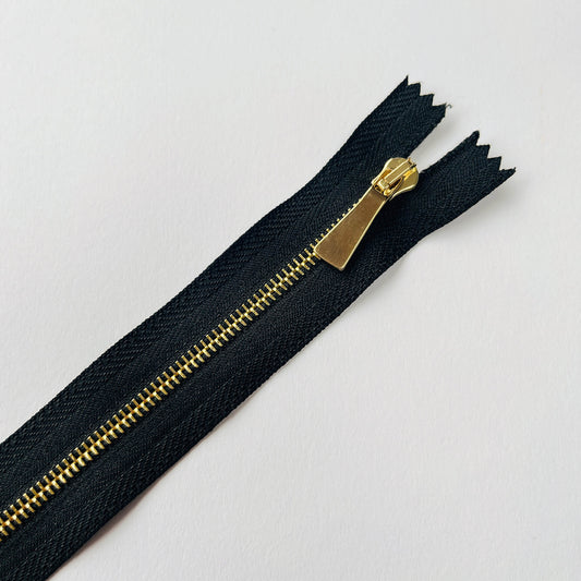 Close up of #3 Slim Profile Closed End Zip with black tape and Gold teeth & puller - 20cm length