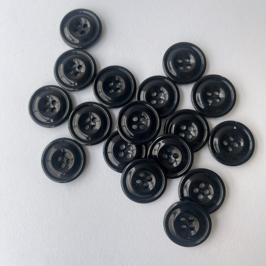 A group of Black Codelite Milk Buttons   of various sizes on a clean white background. Codelite buttons - plastic free, organic & sustainable.