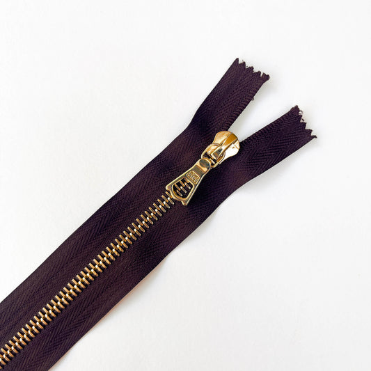 close up of Dark Plum, dark purple  RiRi #6 Metal Zip - 17cm  by RiRi with gold metal teeth and decorative puller - Kleins Haberdashery