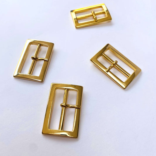 Gold Rectangle Prong Buckle - 30mm.Four gold rectangular buckles on a white background