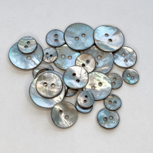 Natural Akoya shell buttons with a beautiful iridescent sheen. Also known as Mother of Pearl or Agoya shell, in five sizes from 10mm to 18mm.
 - Kleins Haberdashery
