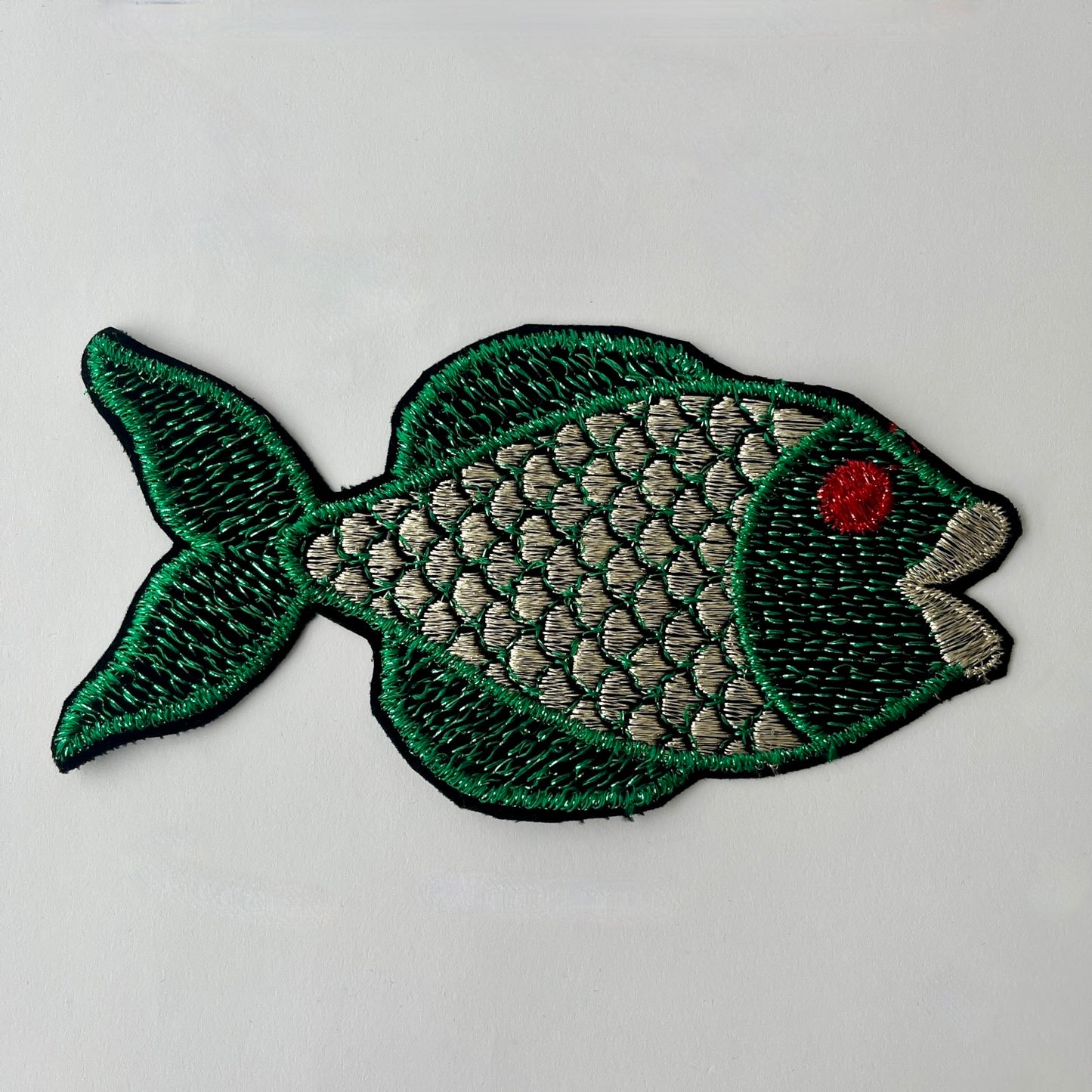 Large embroidered fish patch with metallic thread swimming to the right