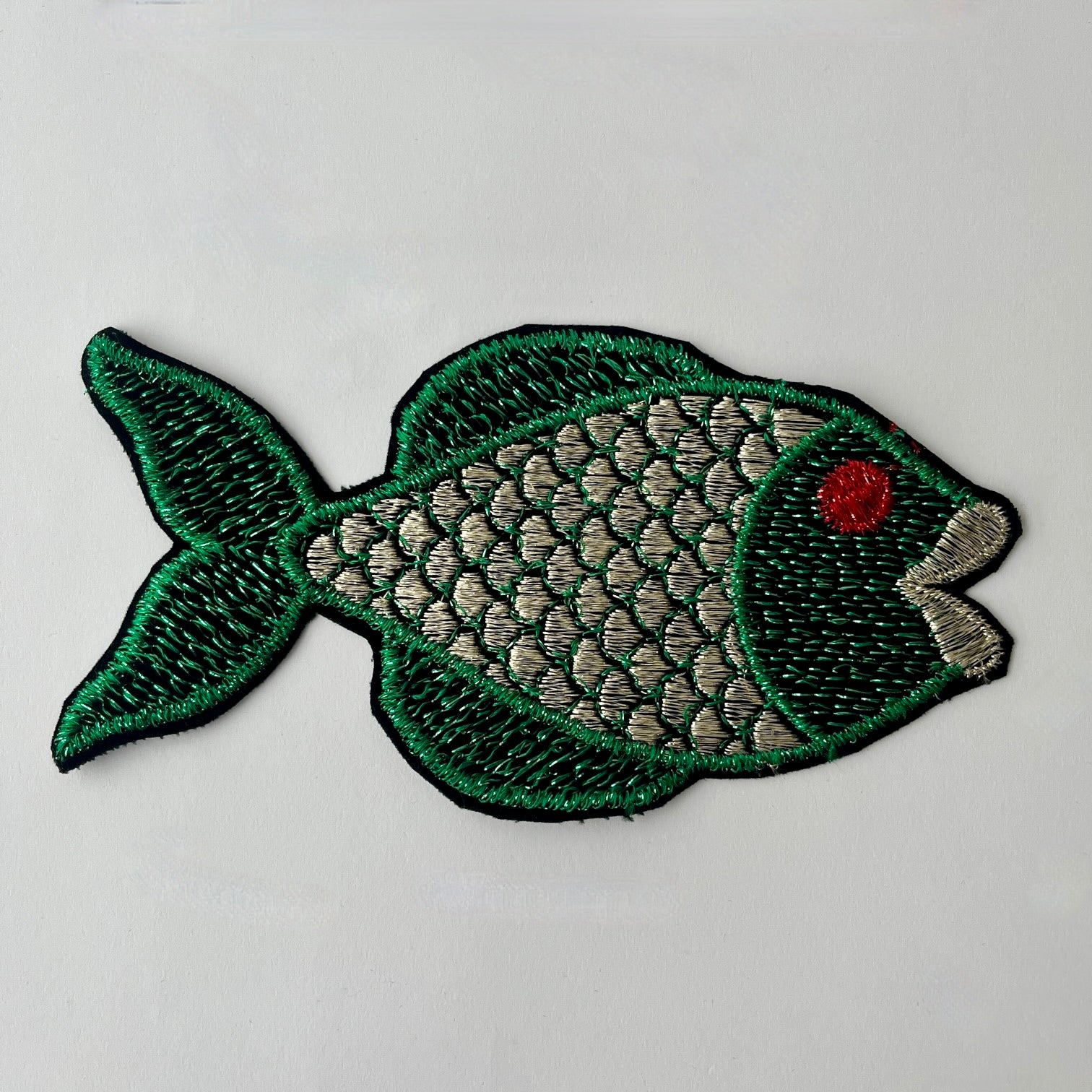 Large embroidered fish patch with metallic thread swimming to the right