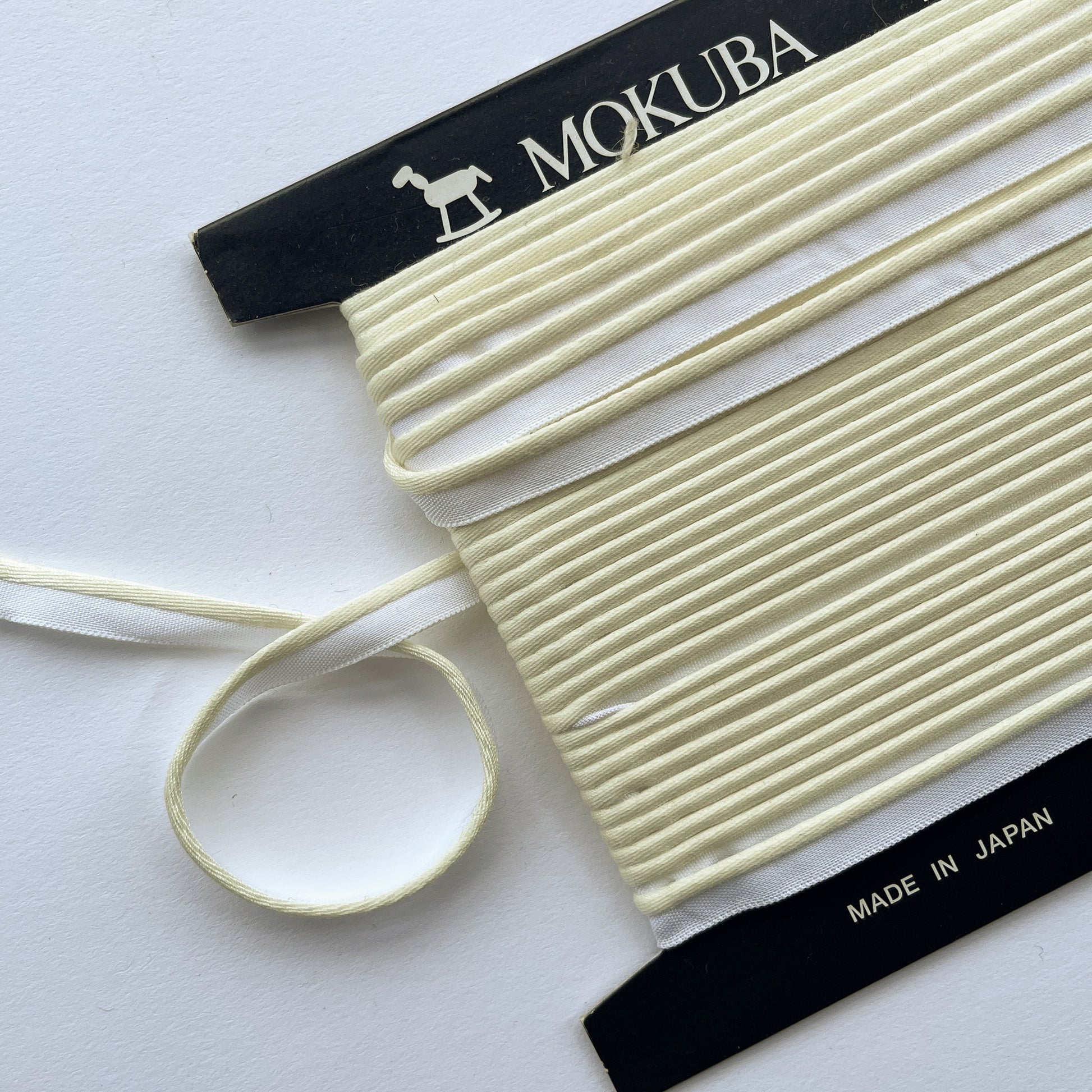 Mokuba cream piping cord
 on a white background
