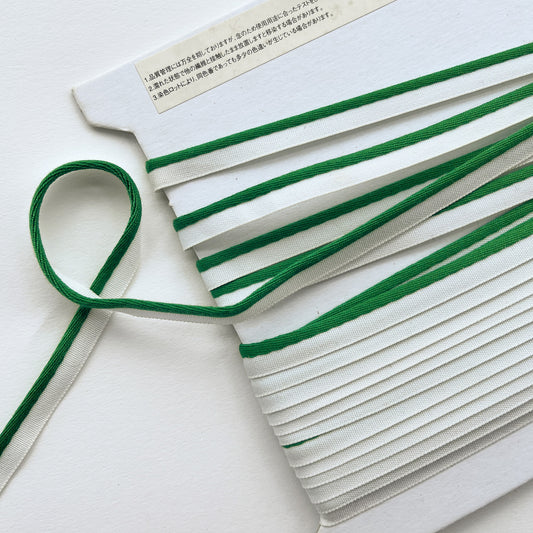 Mokuba green and white piping cord
 on a white background
