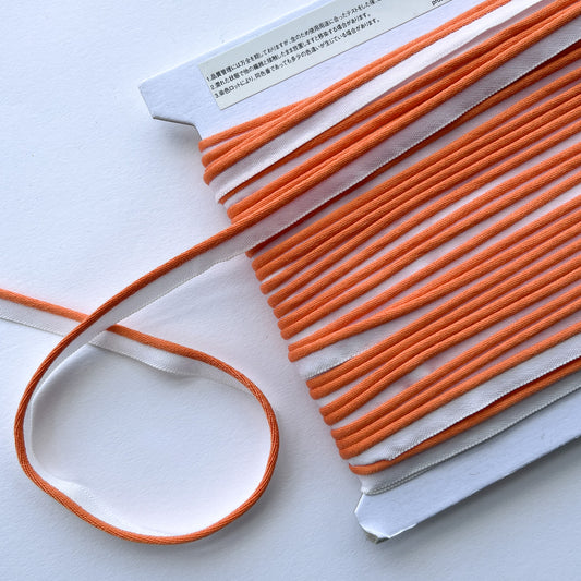 Mokuba orange piping cord
 on a white background
