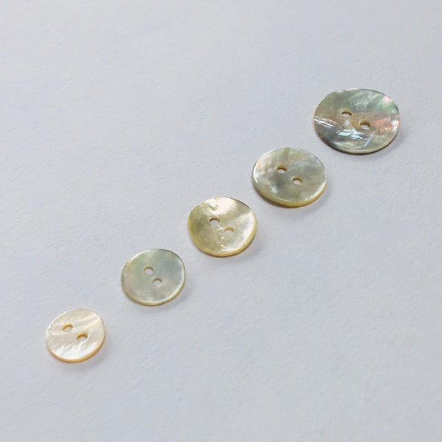 Natural Akoya shell buttons with a beautiful iridescent sheen. Also known as Mother of Pearl or Agoya shell, in five sizes from 10mm to 18mm.
 - Kleins Haberdashery