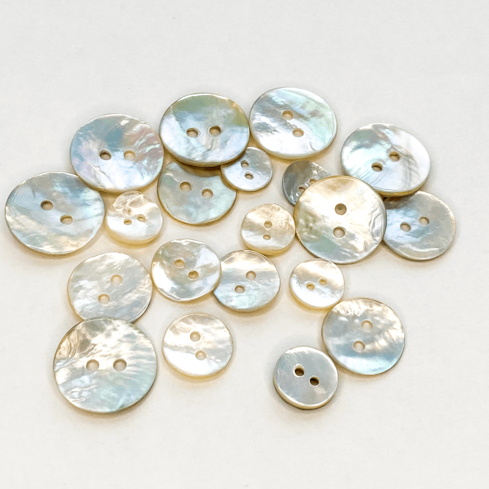 Natural Akoya shell buttons with a beautiful iridescent sheen. Also known as Mother of Pearl or Agoya shell, in five sizes from 10mm to 18mm.
