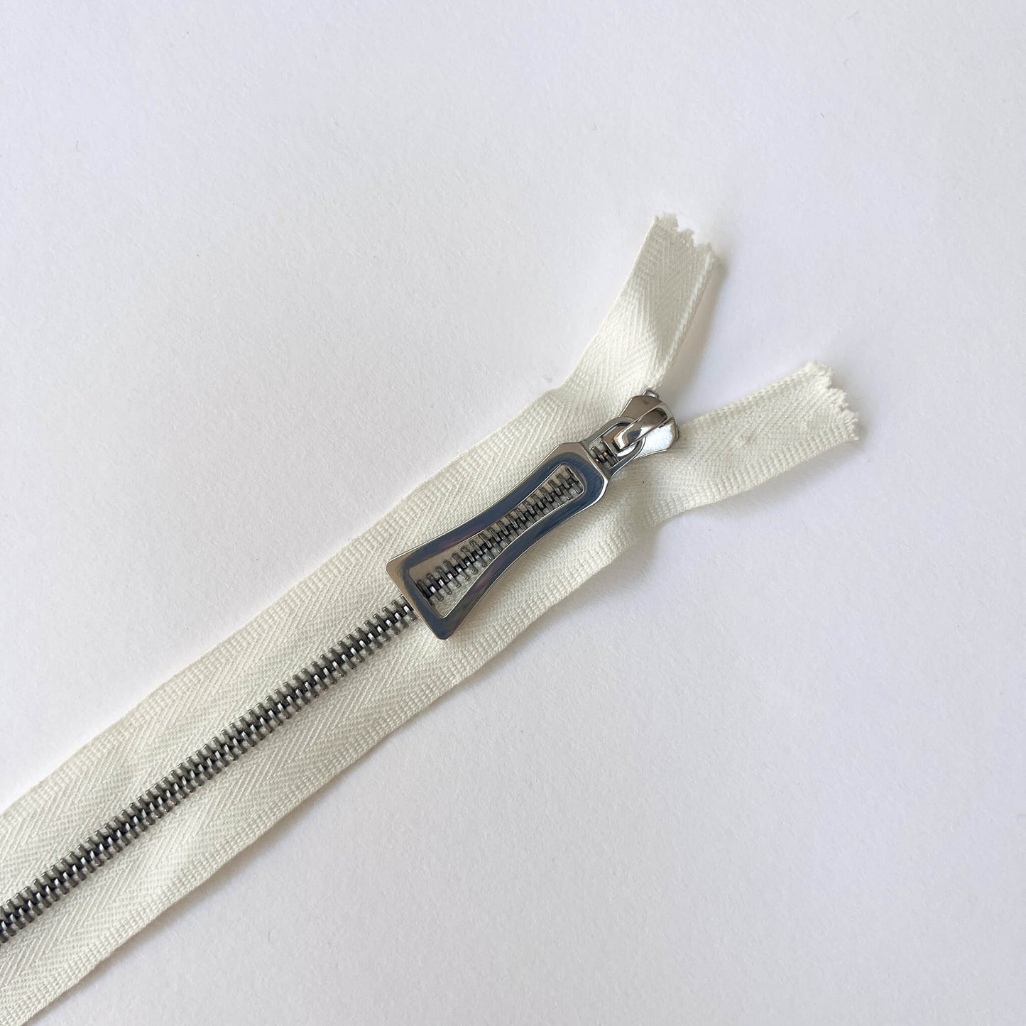 close up of RiRi Zip by RiRi with silver metal teeth and decorative puller - Kleins Haberdashery