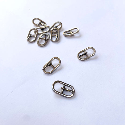 Silver Oval Prong Buckle - 6mm - Set of small metal buckles on a white background