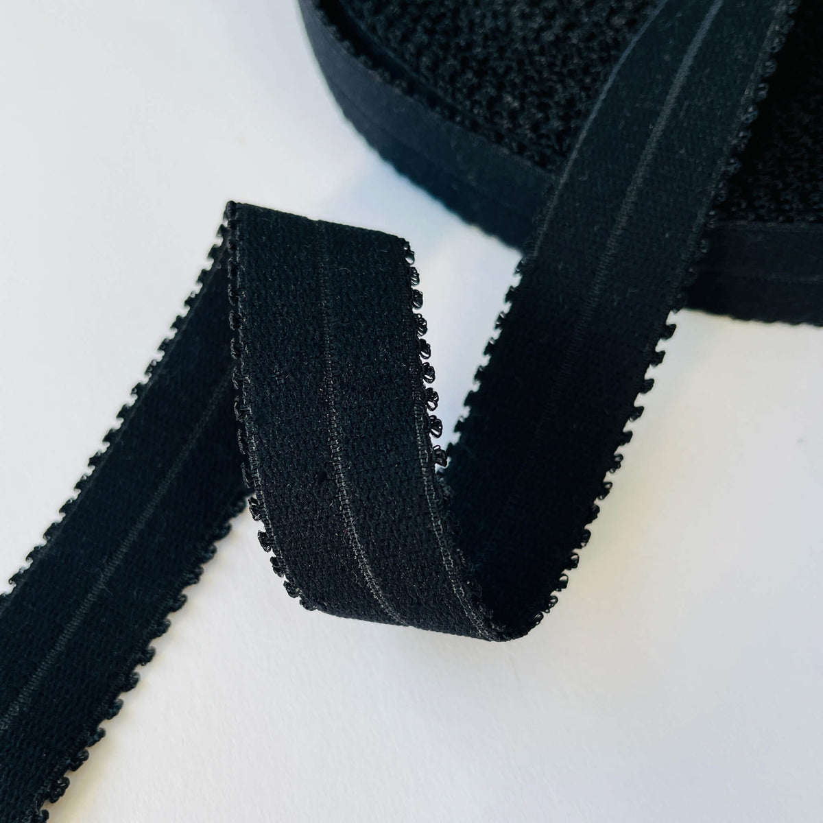 Close up of Strong Stretch Fold Over Picot lingerie Elastic (FOE) in Black, showing central fold line
