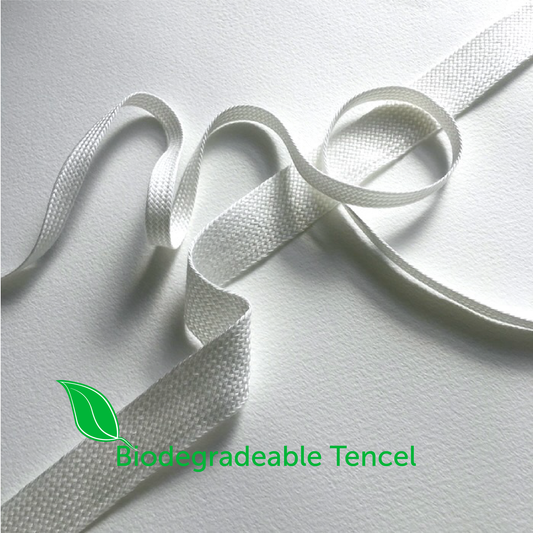 Biodegradable Tencel fabric on a white background with a green leaf logo.