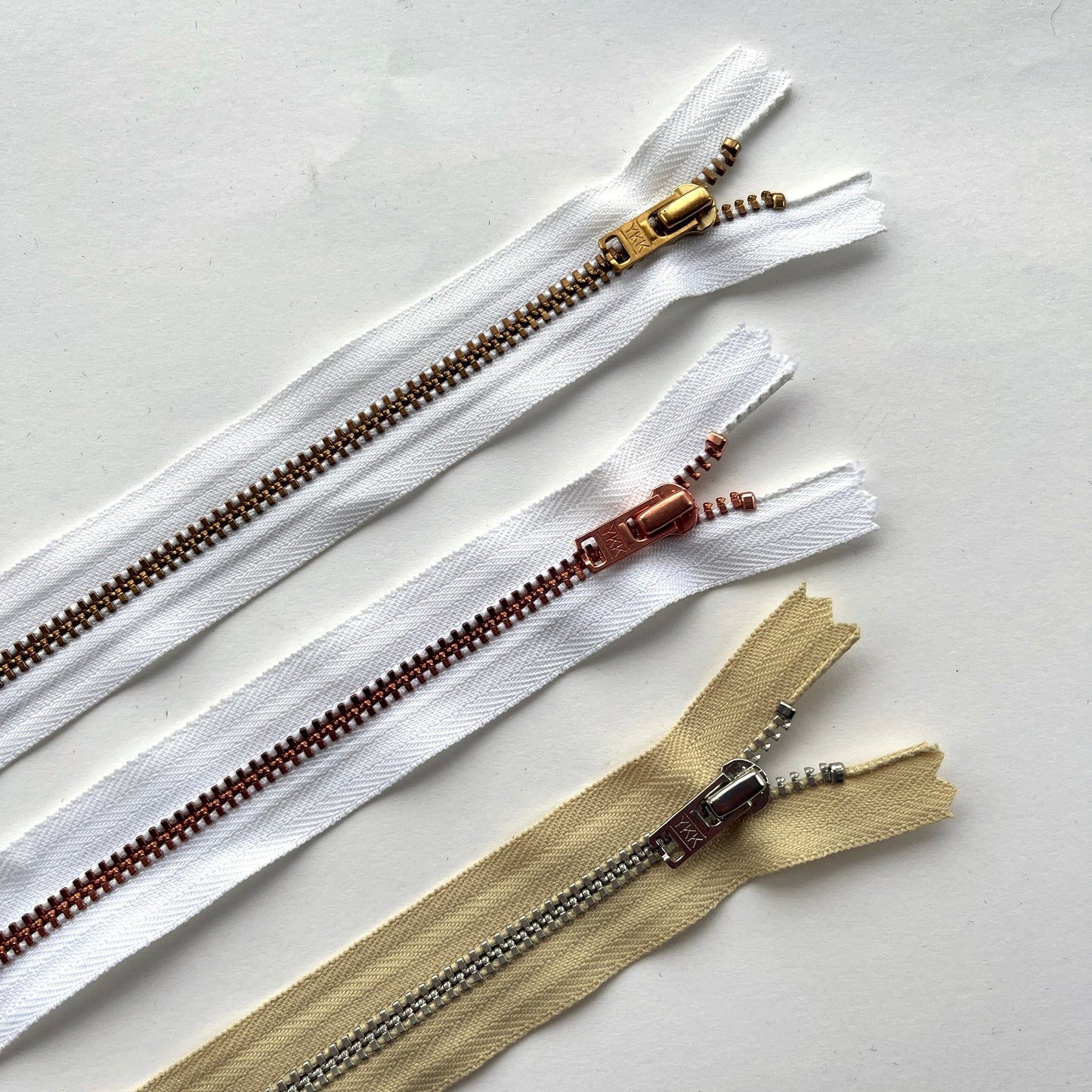 YKK  jeans zip with metal teeth and auto-lock puller in various neutral and white shades - Kleins Haberdashery