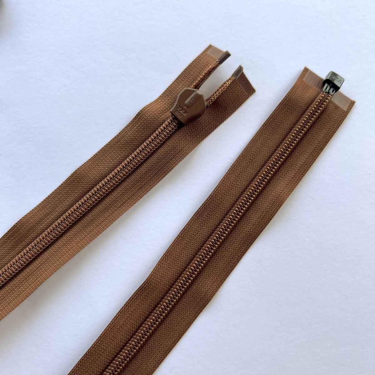 Reverse of YKK Light weight open ended invisible, concealed, zip in brown