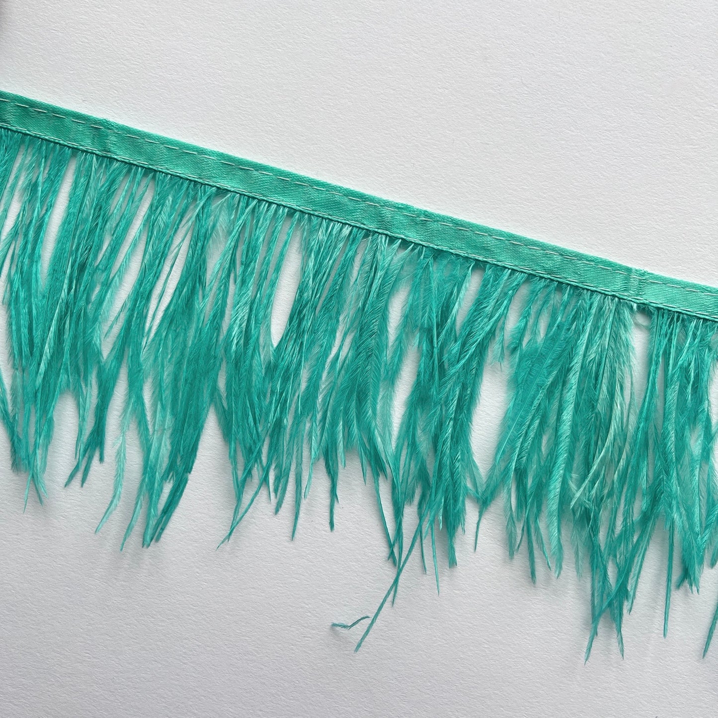 10cm deep Real ostrich feather fringe trim on a Satin ribbon for easy attachment. Would look incredible added to a jacket as a statement cuff!  Ideal for dressmaking, crafts, millinery, costumes, hat making, fascinators, bridal accessories, headpieces, bags.