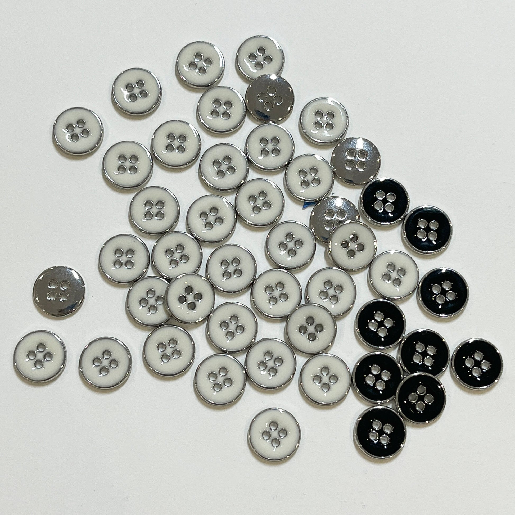 4 hole enamelled shirt buttons. The enamel sits inside a silver polished casing