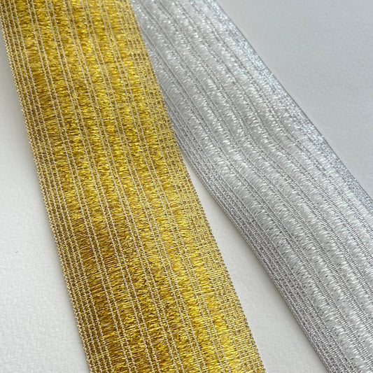 Live out your best disco dreams with these glorious lurex elastics! This stitched metallic elastic is perfect for adding a bit of sparkle and stretch to a waistband, cuff or elasticated belt. Can be worn directly against the skin as it is soft and non-scratchy on the reverse side.