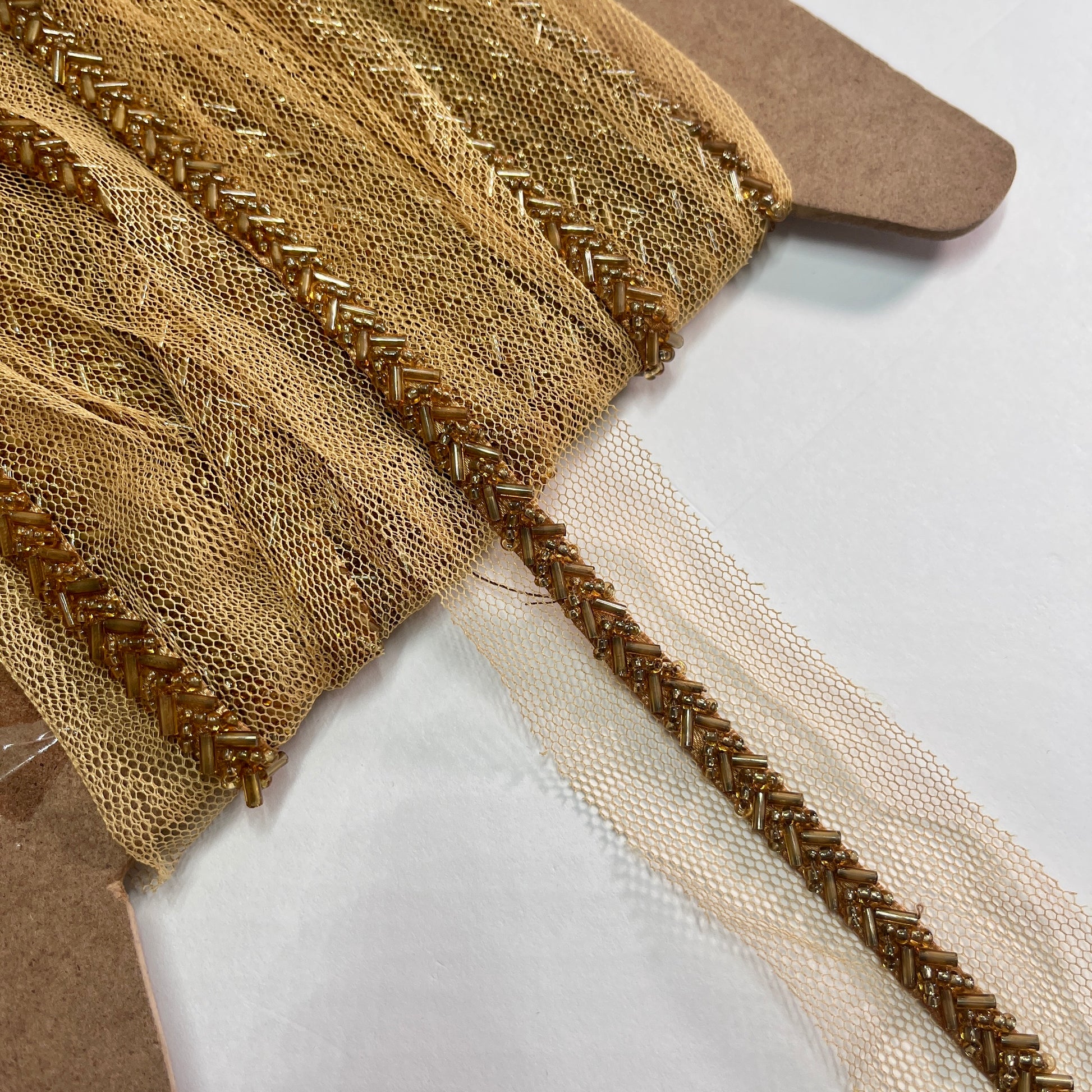 Beautiful bugle bead trim, hand beaded on a tulle netting. Popular for bridal wear, evening wear, crafts, jewellery and headband making.