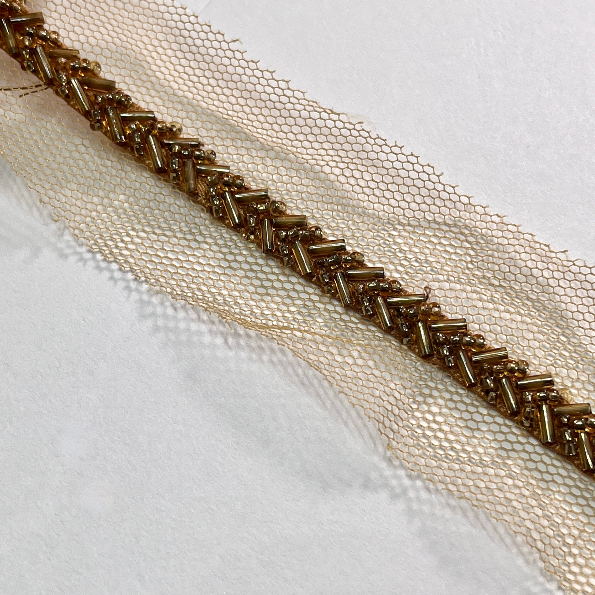Beautiful bugle bead trim, hand beaded on a tulle netting. Popular for bridal wear, evening wear, crafts, jewellery and headband making.