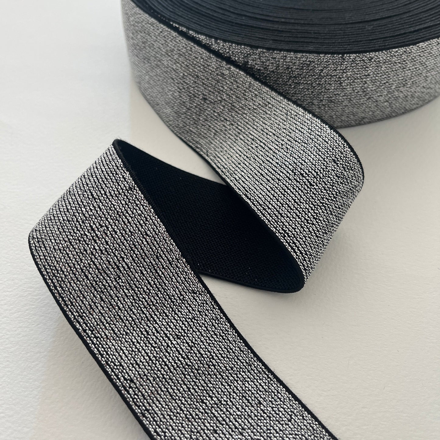 How fabulous are these lurex elastics? Perfect for adding a bit of sparkle and stretch to a waistband, cuff or elasticated belt. Can be worn directly against the skin as it is soft and non-scratchy on the reverse side. silver sparkly elastic
