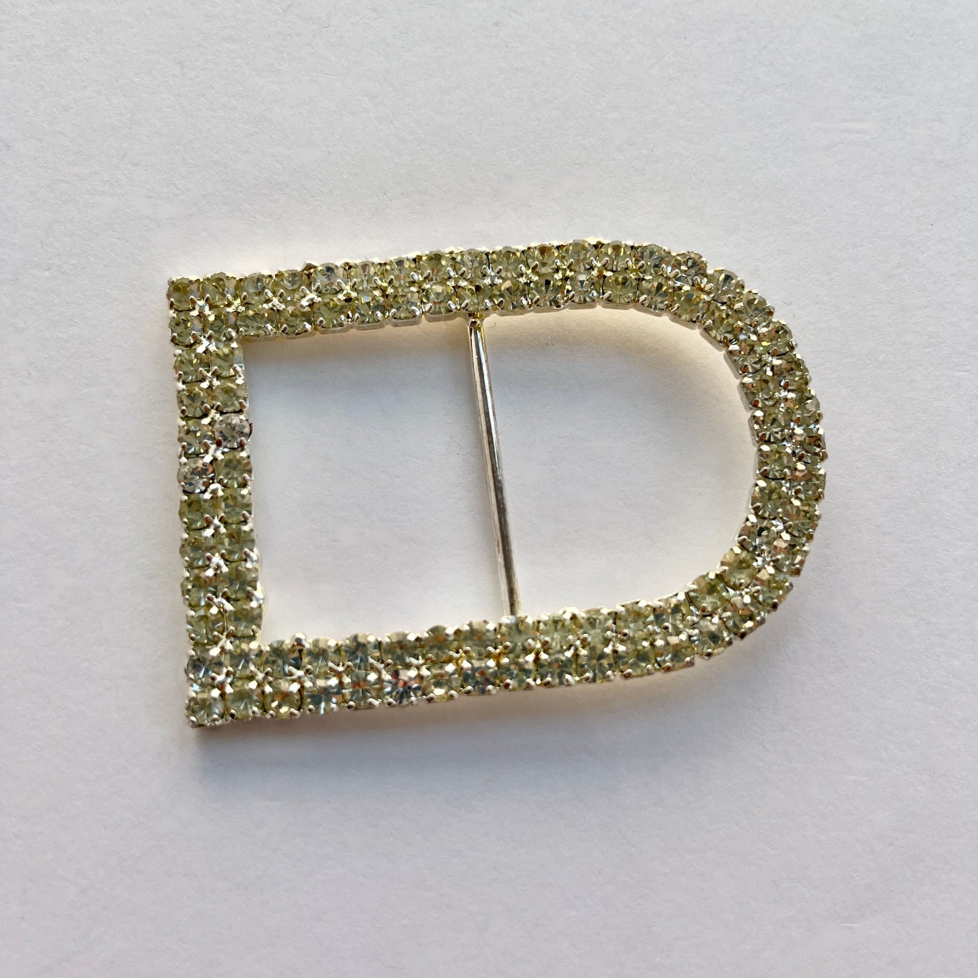 Large D shaped silver rectangle diamante buckle with a double row of rhinestones. Use as a belt buckle, an accent for straps, dressmaking projects or as an embellishment for handbags, wedding invitations, wedding favours, napkin rings and arts and craft projects. 