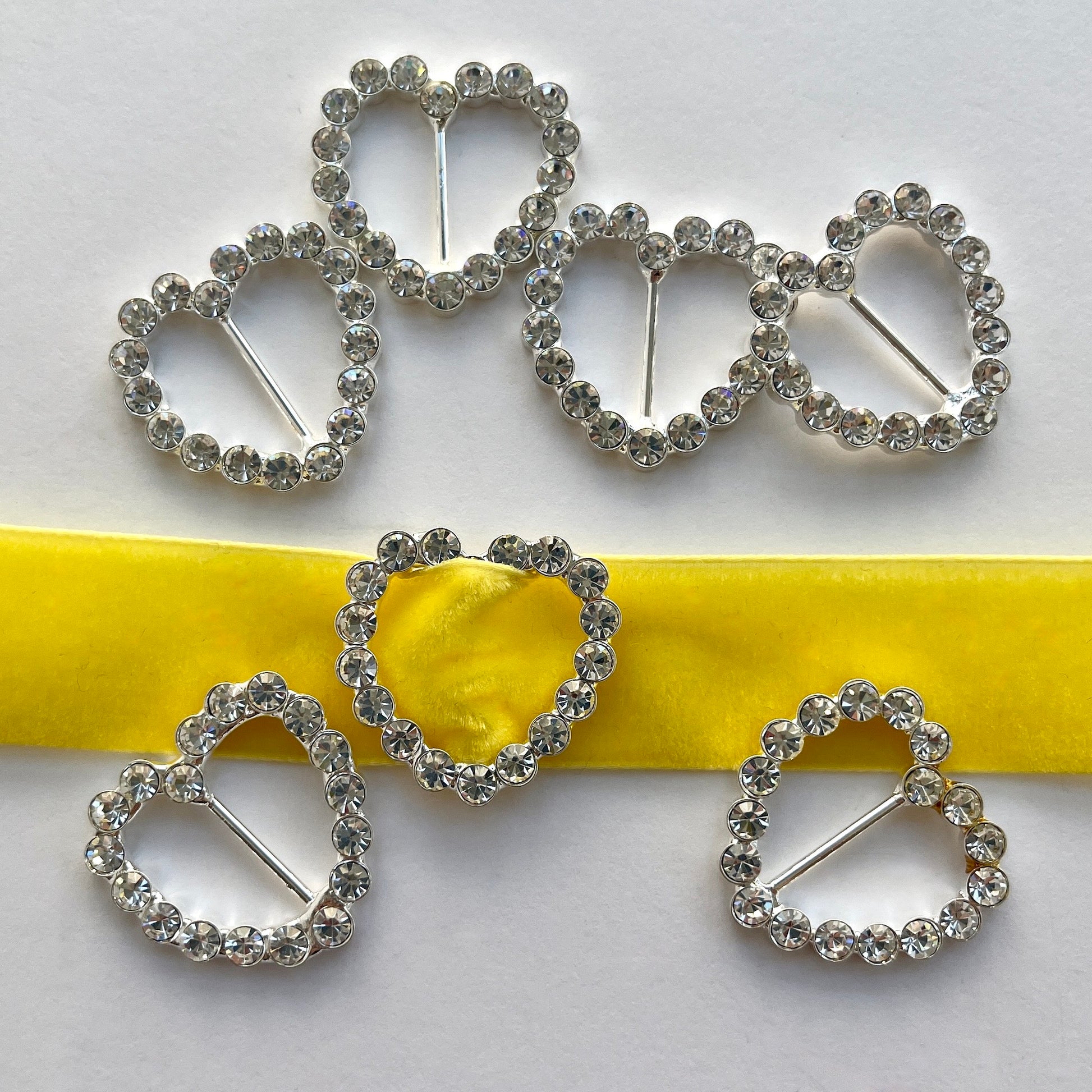 Lovely, high quality, rhinestone crystal slider buckles. Easy to use, just slide onto a ribbon or a strap to add sparkle to dress straps, bags. Perfect for a spot of DIY to embellish wedding invitations, wedding favours, napkin rings and arts and craft projects. Shown on 1cm (⅜”) wide velvet ribbon. 