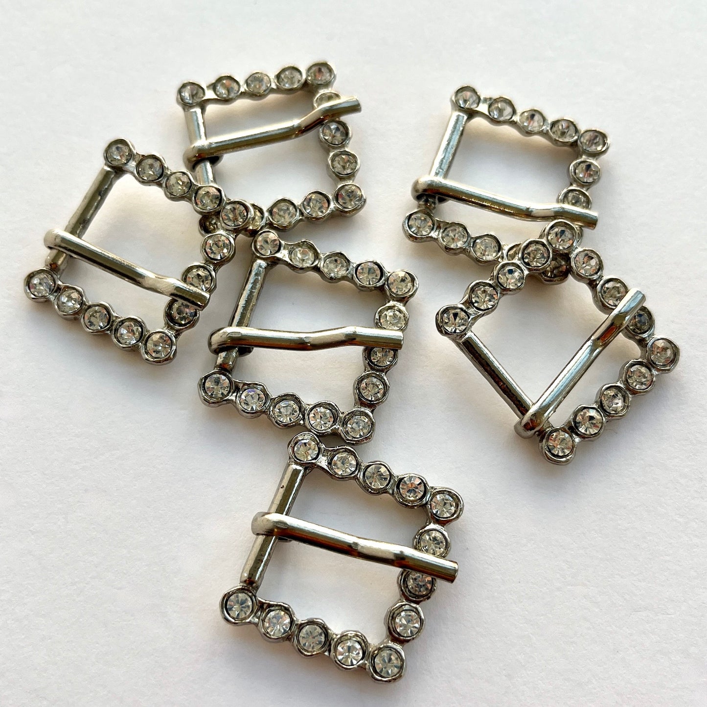 Small silver rectangle diamante buckle. Use as a belt buckle, an accent for straps, dressmaking projects or as an embellishment for handbags, wedding invitations, wedding favours, napkin rings and arts and craft projects. Would fit an approximate belt or strap width of 2cm