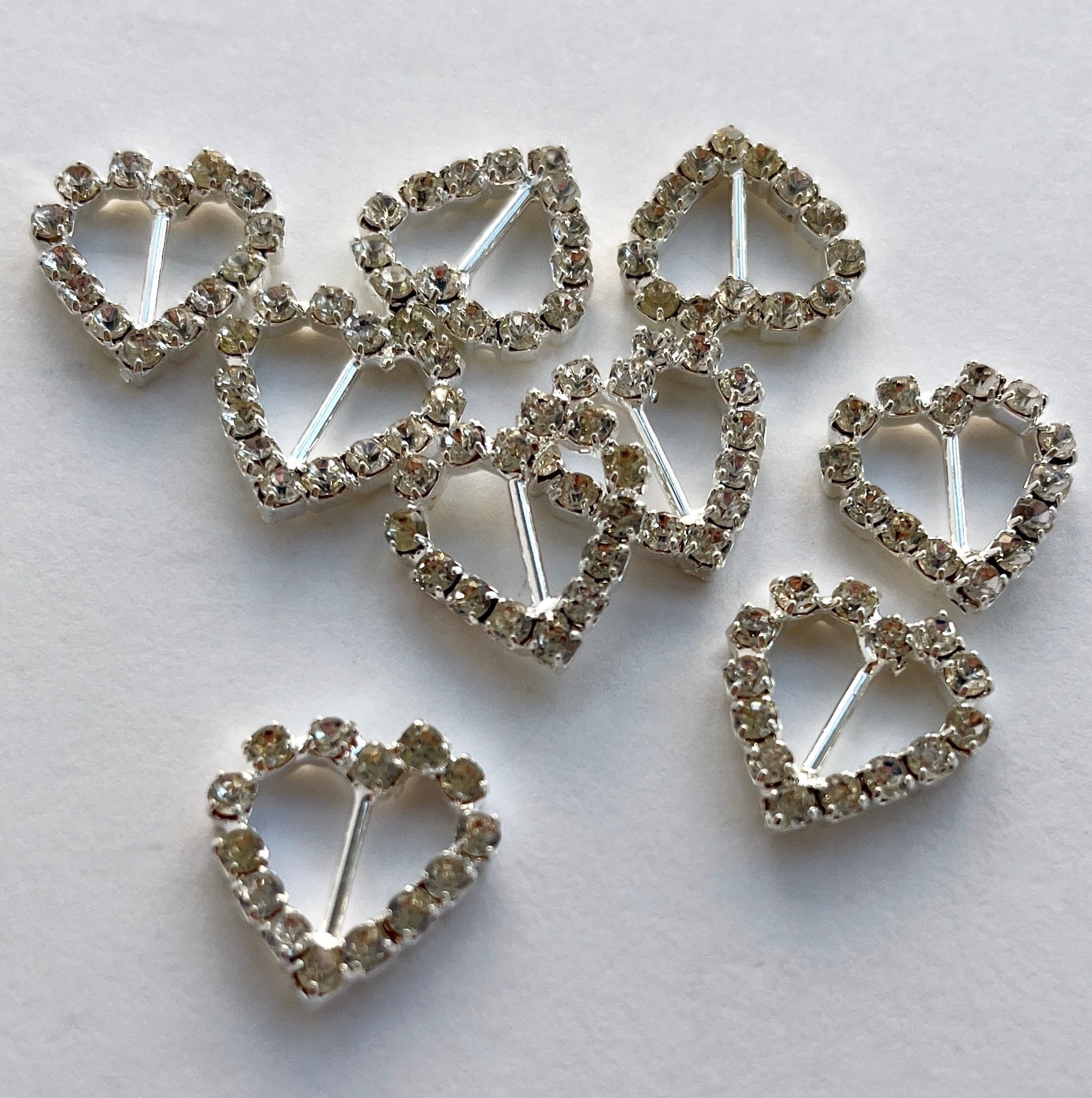 Lovely, high quality, rhinestone crystal slider buckles. Easy to use, just slide onto a ribbon or a strap to add sparkle to dress straps, bags. Perfect for a spot of DIY to embellish wedding invitations, wedding favours, napkin rings and arts and craft projects. Shown on 1cm (⅜”) wide velvet ribbon. 