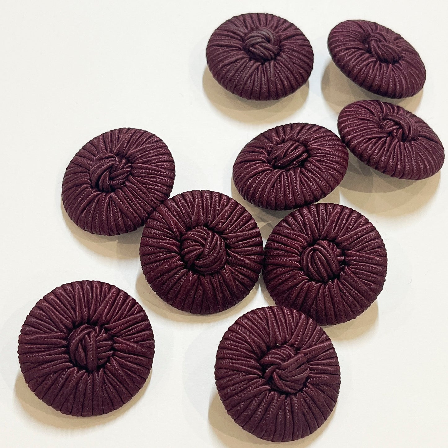 BURGANDY 32MM Vintage passementerie cord buttons, we believe to be from the 1980s. Would make a beautiful feature button on a cape, coat or jacket, and the perfect button for bridal wear or evening wear. Buttons backs are plastic with a loop shank.
