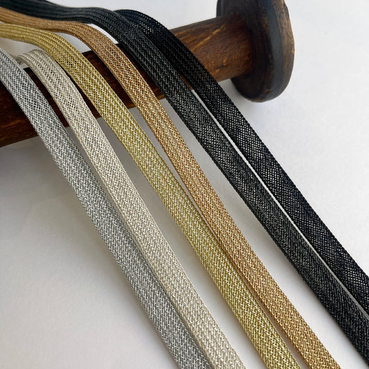 Beautiful and supple, this metallic plaited braiding has a clear plastic strip inside for extra strength and durability making it ideal for many applications including dress or bag staps. The internal plastic strip may be removed if desired 
