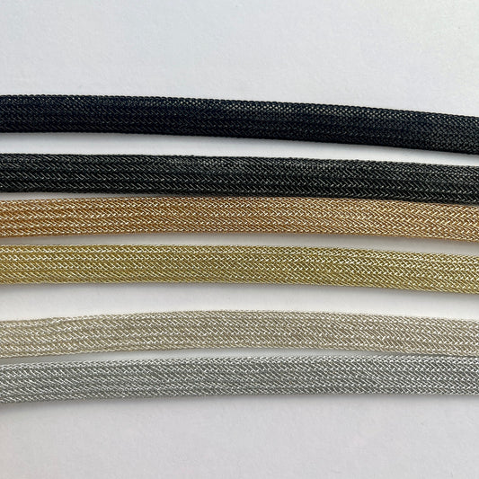 Beautiful and supple, this metallic plaited braiding has a clear plastic strip inside for extra strength and durability making it ideal for many applications including dress or bag staps. The internal plastic strip may be removed if desired 
