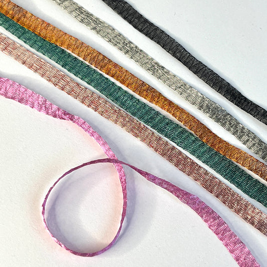 Metallic Woven Tubular Braid  Knitted metallic mesh trim that could be used for straps or used for jewellery creations. Tthe trim can be pulled from either side to create unique shaped contortions.