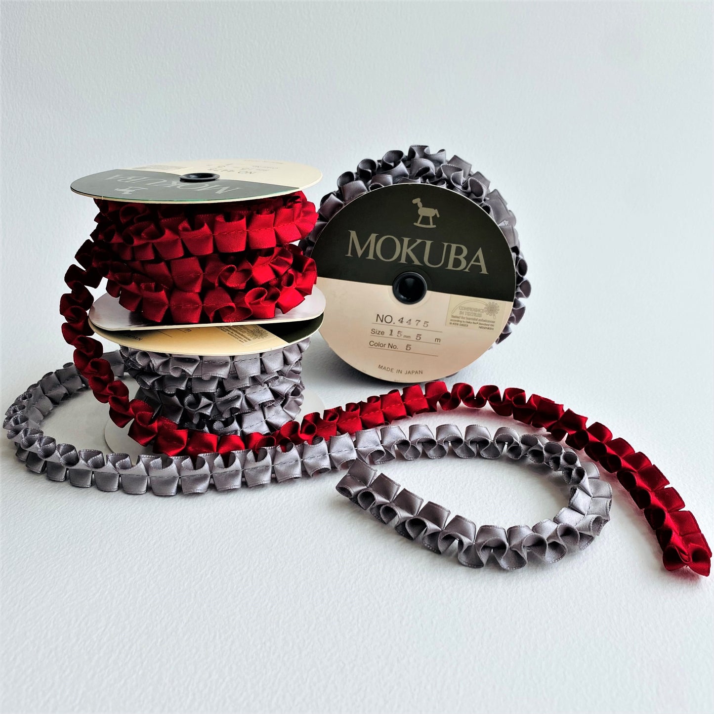 15mm Pleated Satin ribbon by MOKUBAA beautifully soft pleated satin ribbon trim by Mokuba, carefully gathered, held together by a single stitch running through the middle, which comes in two beautiful colours.