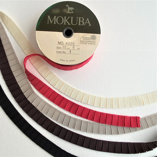 15mm Pleated Grosgrain ribbon by MOKUBA A beautifully soft pleated Grosgrain ribbon trim by Mokuba, carefully gathered, held together by a single stitch running near the top, which comes in five stunning colours.
