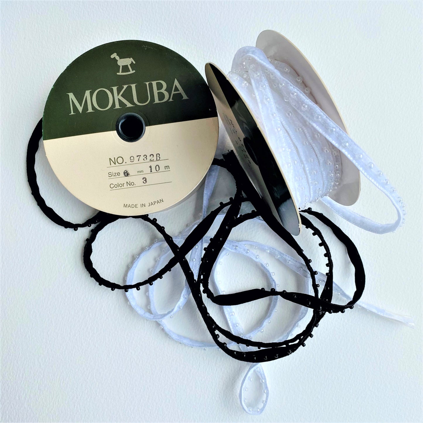 6mm Beaded Velveteen Ribbon by MOKUBA A beautifully soft beaded Velveteen ribbon trim by Mokuba that comes in two colours.