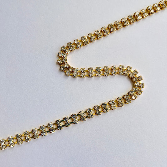 Unusual 2 row sparkly rhinestone trim - premium high grade diamanté crystals set in a flexible metal chain casing. Popular for bridal wear, evening wear, crafts, jewellery and headband making.