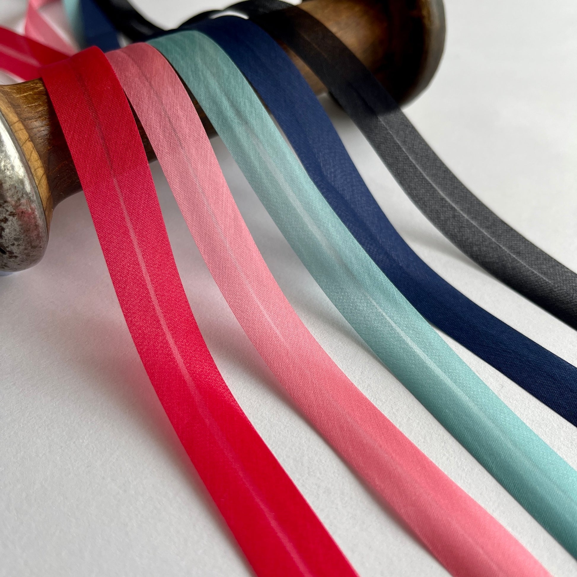 A beautiful silk organza, double folded, bias binding used to finish the edges of sheer and fine fabrics. Perfect for bridal wear, lingerie and bra making. Red bias, pink bias binding, black bias binding, navy bias binding , turquoise binding