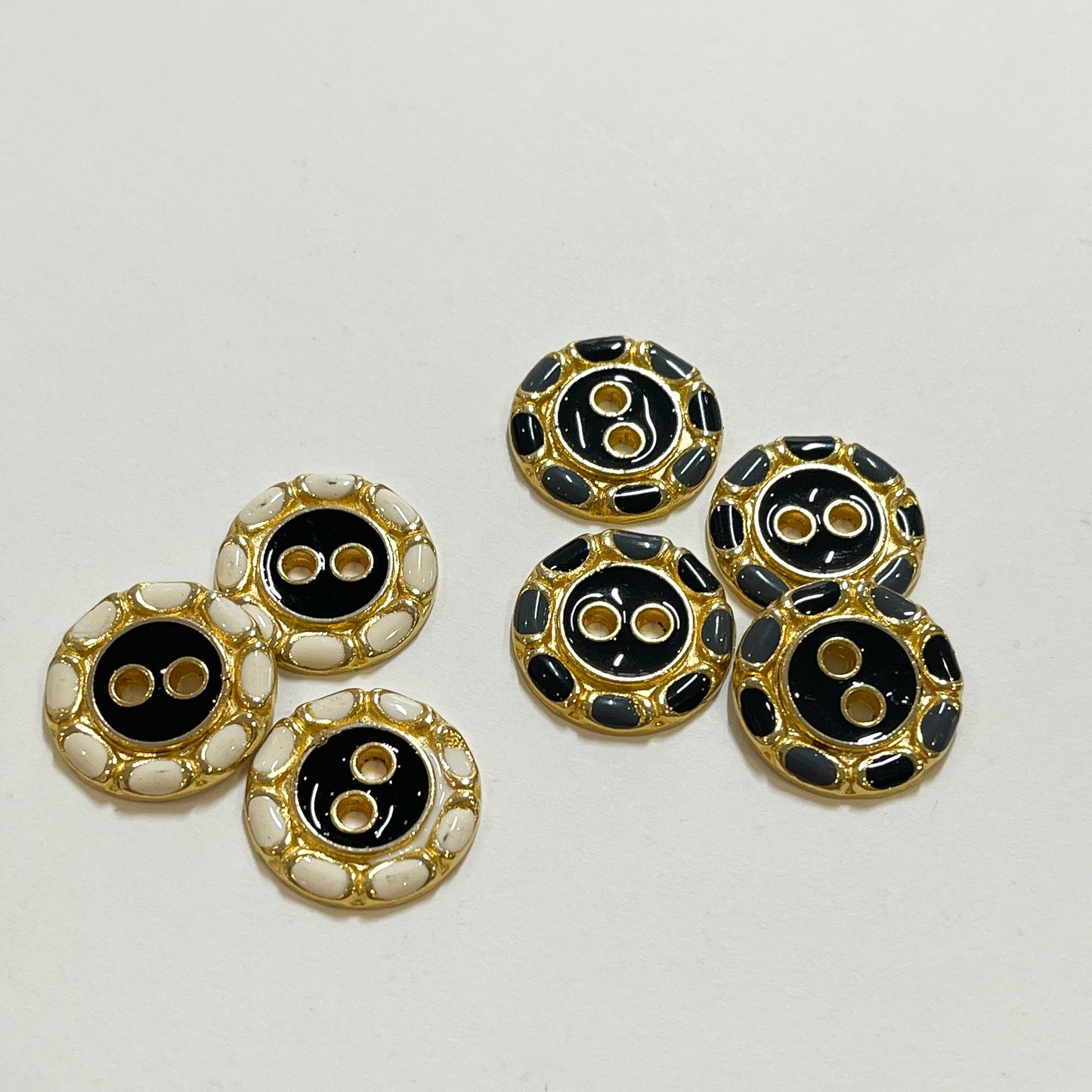 Beautiful enamelled buttons from the 1980s. We have very limited stock and these buttons are available in black/white as a set of 3 or in navy/blue as a set of 4.