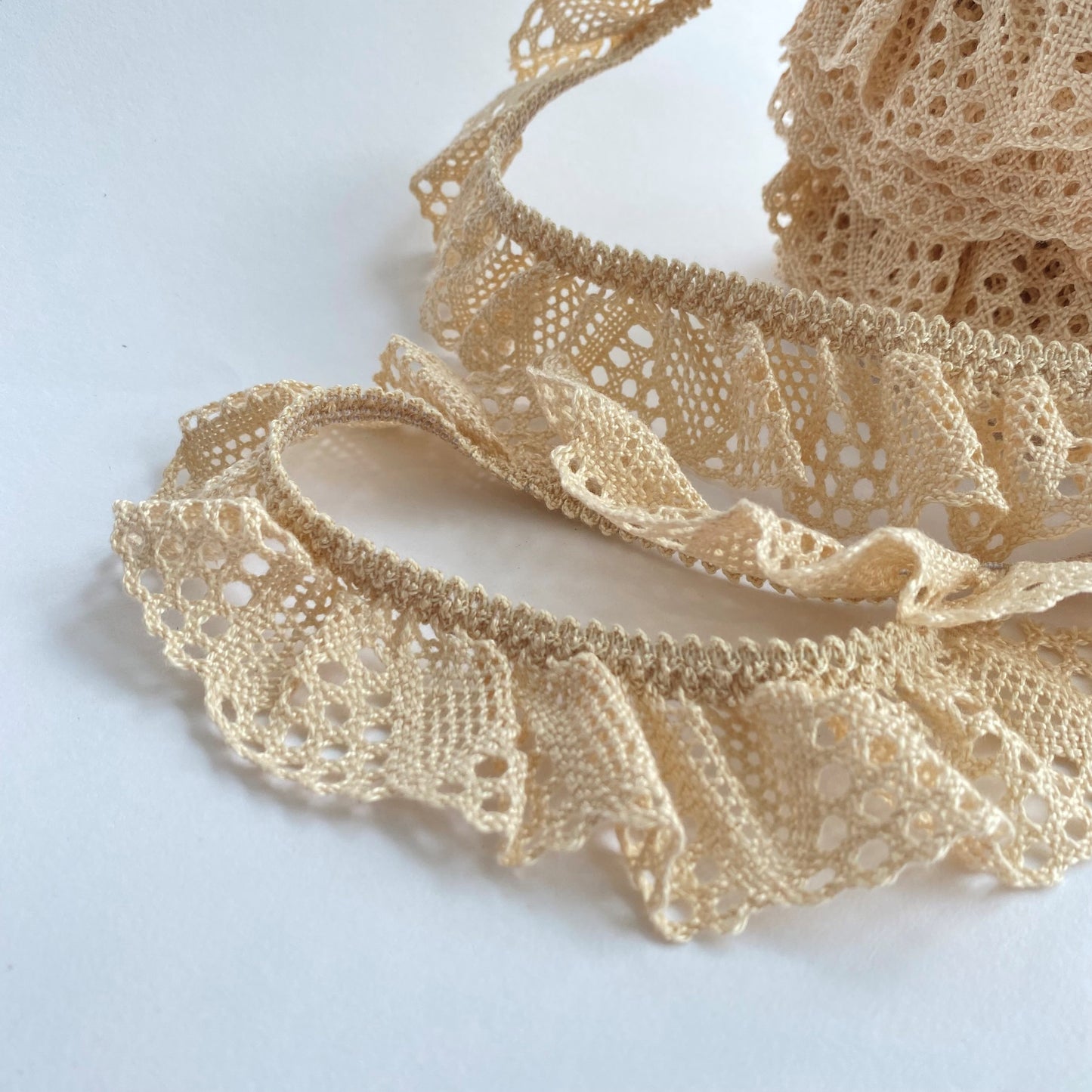 40mm wide Ruffled Cluny, macramé, crochet lace trim with a stretchy edge. This lace is eco friendly as the cotton is Oeko Tex 'Made in Green' standard.