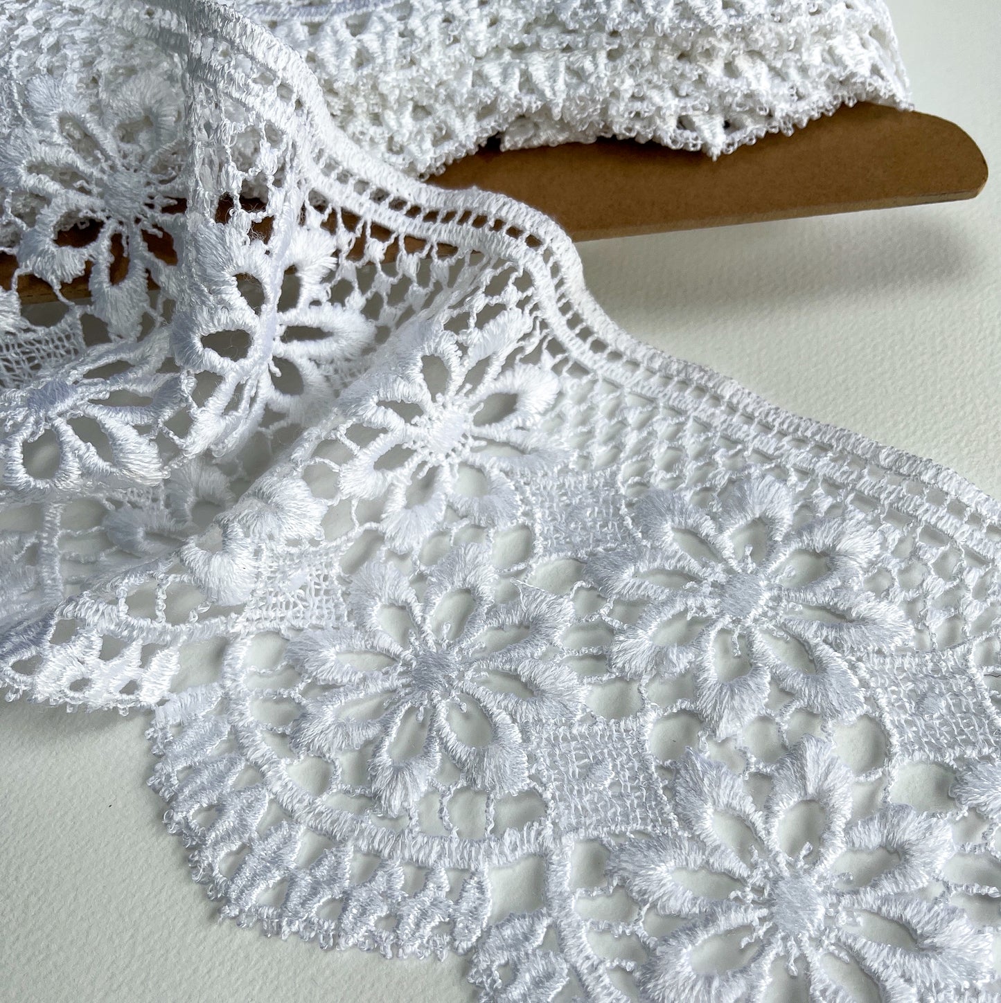 15cm Beautiful, deep guipure bridal lace trim with delicate scroll design and scalloped edge.