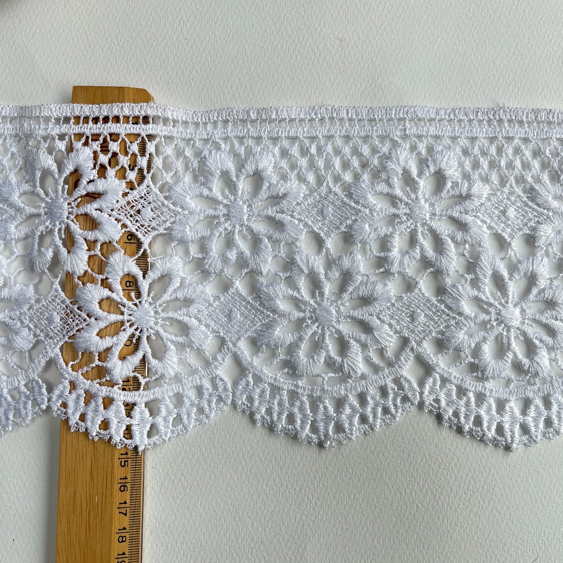 15cm deep guipure bridal lace trim with delicate scroll design and scalloped edge.